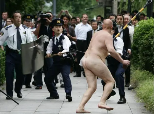 Crazy Naked Bald Man with BricK